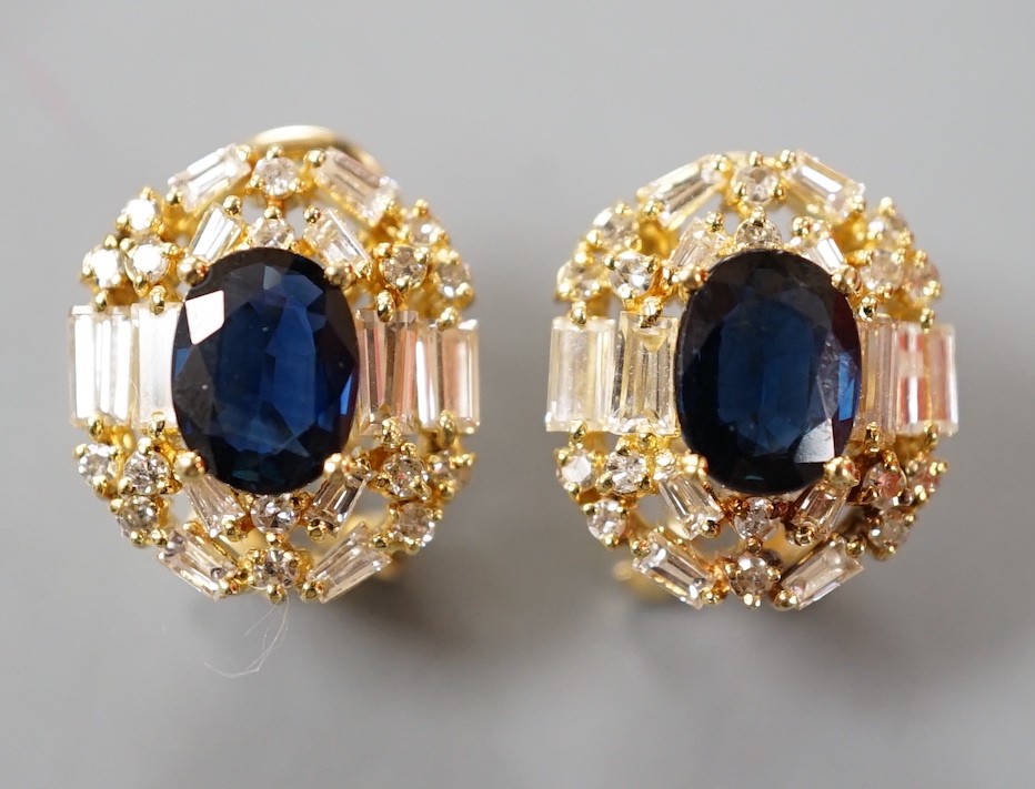 A pair of modern 750 yellow metal, sapphire and diamond set oval cluster earrings, 16mm, gross weight 8.2 grams.